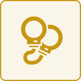 Gold handcuffs on beige background