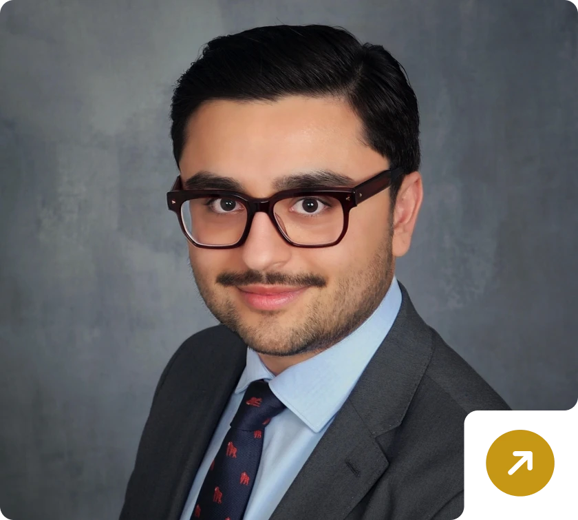 Professional portrait of a bespectacled man smiling