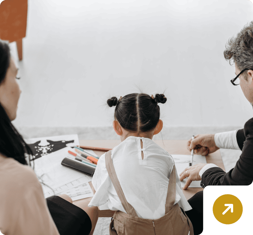 Parents and child engaged in drawing activity