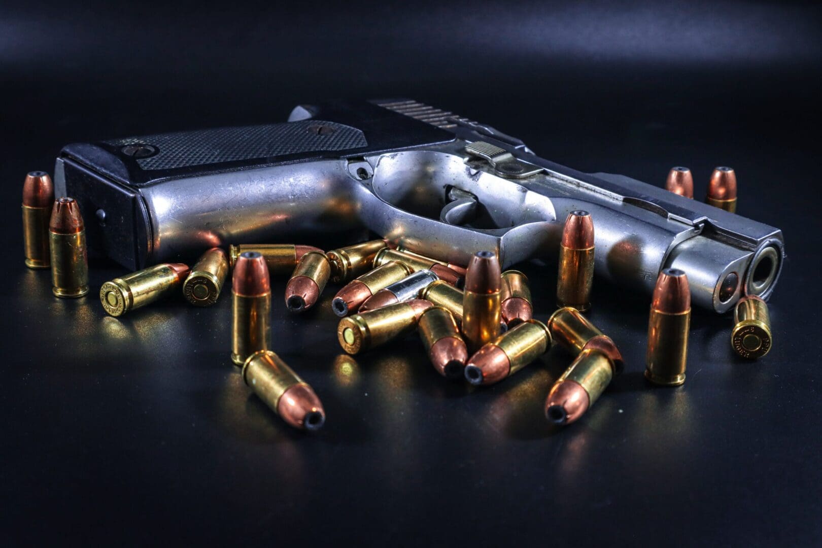 Handgun with scattered ammunition on surface.