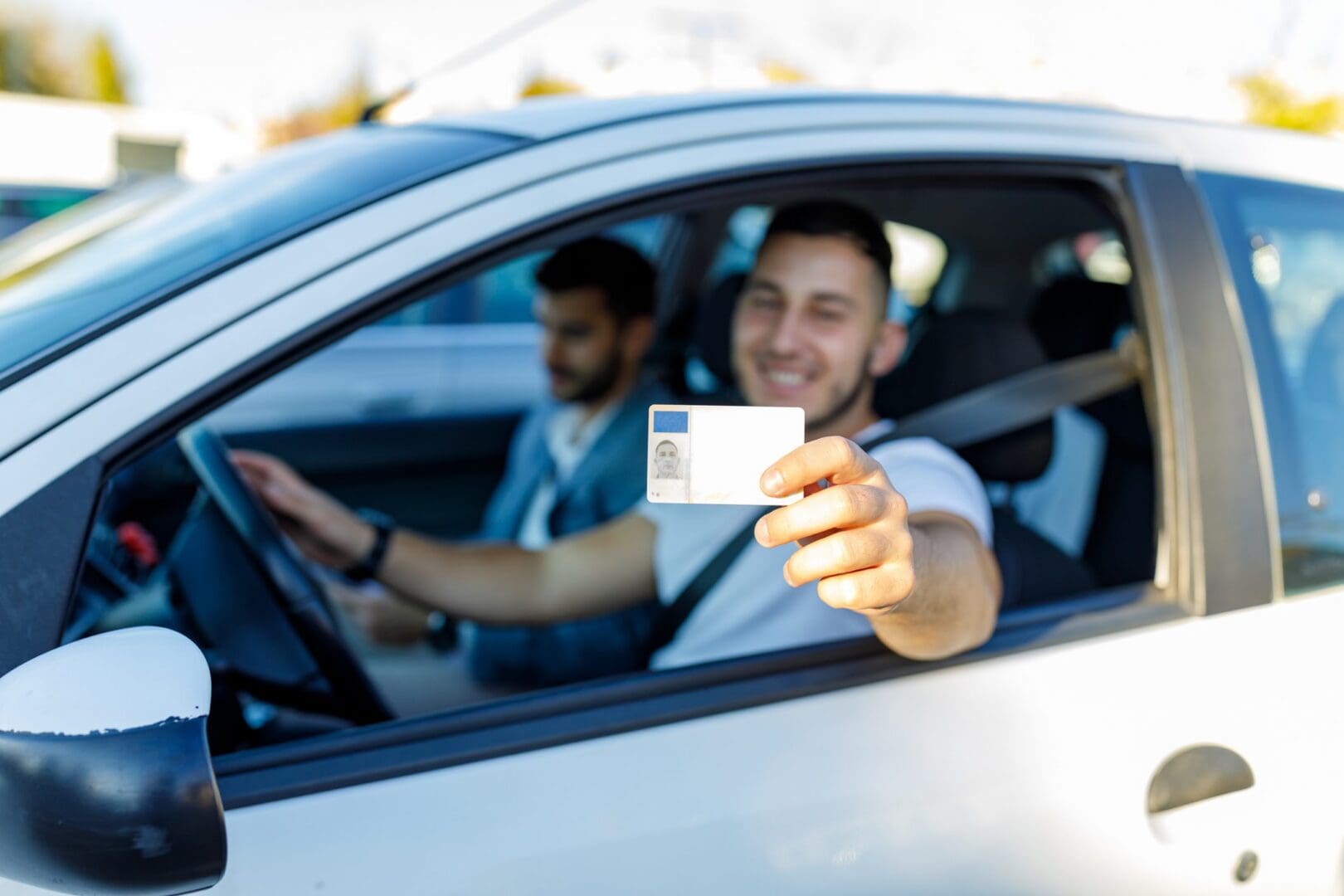Person holding ID card while driving